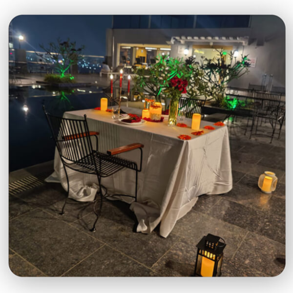Pool Side Candle Light Dinner with Elegant Setup by Le Meridian
